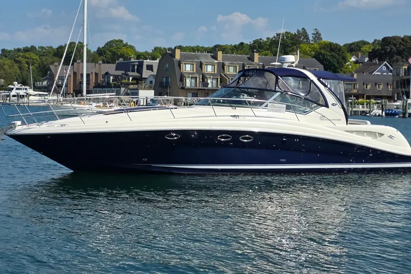 The Image of 2004 Sea Ray 420 Sundancer yacht docked in a scenic marina setting. - 0