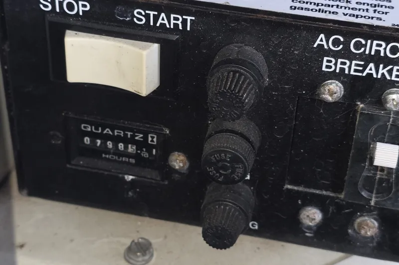 Slide: The Image of Control panel of a 2004 Sea Ray 420 Sundancer boat with hour meter and switches. - 46