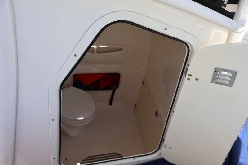 Slide: The Image of Interior view of a 2009 Boston Whaler 280 Outrage boat's compact restroom. - 9