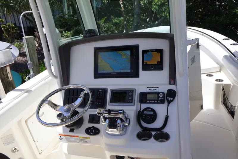 Slide: The Image of 2009 Boston Whaler 280 Outrage helm with navigation screens and controls. - 7