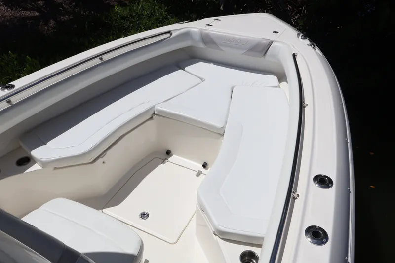 Slide: The Image of 2009 Boston Whaler 280 Outrage boat interior with white cushioned seating. - 11
