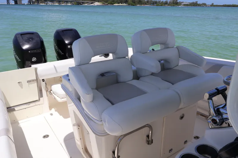 Slide: The Image of 2009 Boston Whaler 280 Outrage boat interior with dual seats and twin Mercury engines. - 5