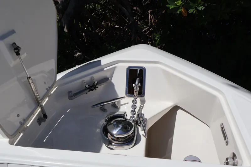 Slide: The Image of Anchor compartment of 2009 Boston Whaler 280 Outrage boat, featuring chain and winch. - 8