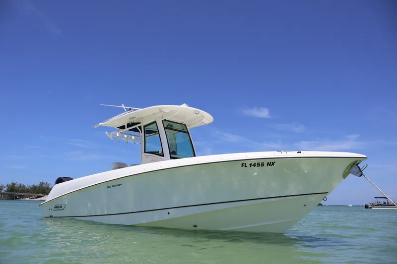 Slide: The Image of 2009 Boston Whaler 280 Outrage boat on clear water under blue sky. - 1