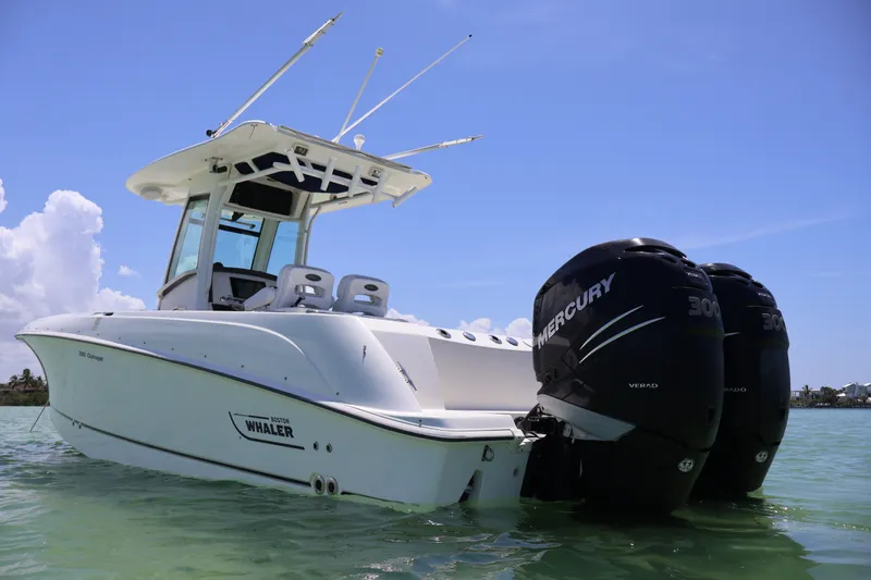 Slide: The Image of 2009 Boston Whaler 280 Outrage boat with twin Mercury engines on water. - 4