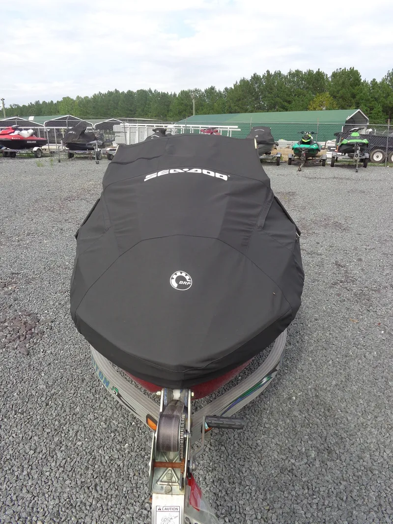 Slide: The Image of A 2024 Sea-Doo RXT-X 325 with a black cover on a trailer. - 31