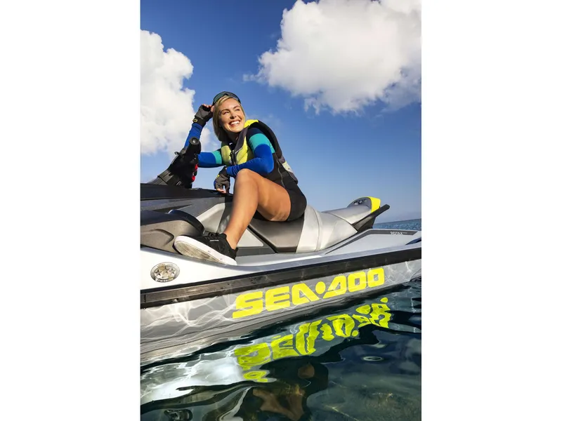 Slide: The Image of A person sits on a Sea-Doo RXT-X 325 jet ski in the water, smiling and relaxed. - 39
