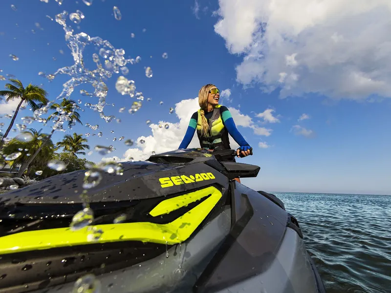 Slide: The Image of A person rides a 2024 Sea-Doo RXT-X 325 on the water, surrounded by palm trees. - 40