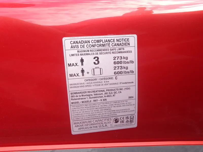 Slide: The Image of Canadian compliance notice on a red 2024 Sea-Doo RXT-X 325. - 28