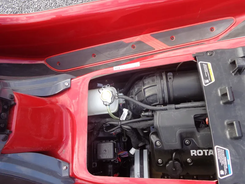 Slide: The Image of Close-up of a 2024 Sea-Doo RXT-X 325 engine compartment, showing visible components. - 25
