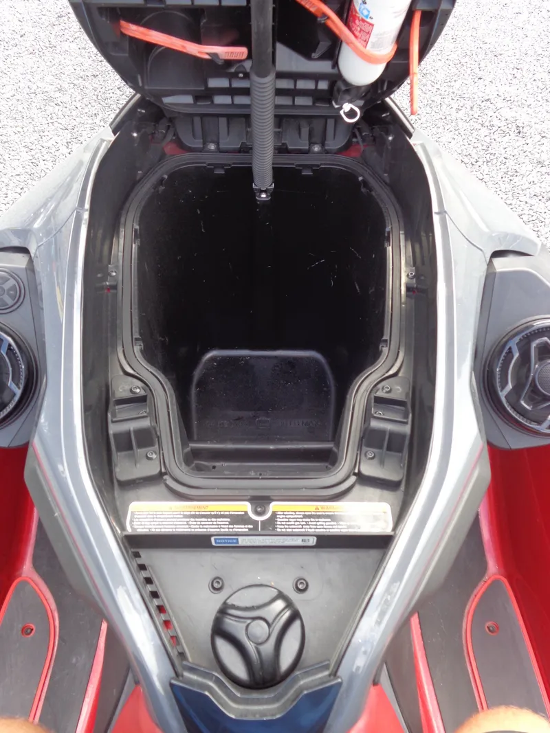 Slide: The Image of A 2024 Sea-Doo RXT-X 325 with an open storage compartment and gray, red design. - 18
