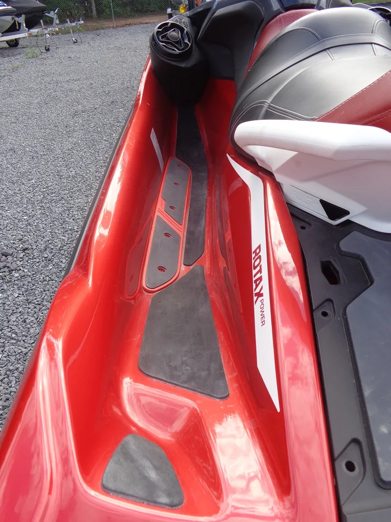 Slide: The Image of Close-up of a red 2024 Sea-Doo RXT-X 325 with black and white seating. - 17