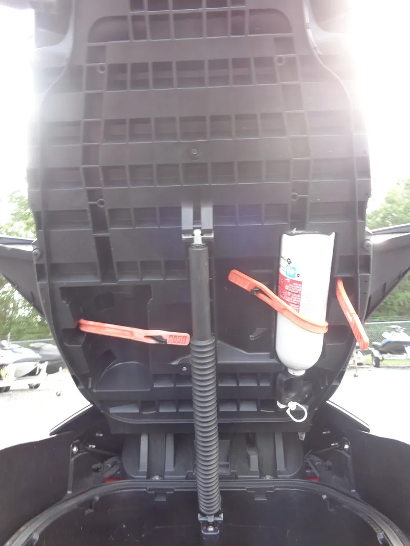 Slide: The Image of An open storage compartment with a fire extinguisher and straps inside. - 19