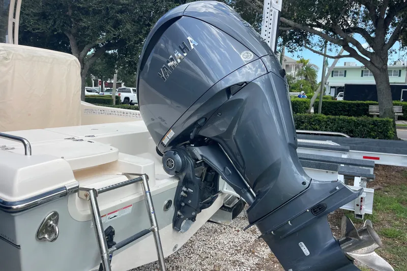 Slide: The Image of 2022 Grady-White 251 Coastal Explorer with Yamaha outboard motor, parked on a trailer. - 16