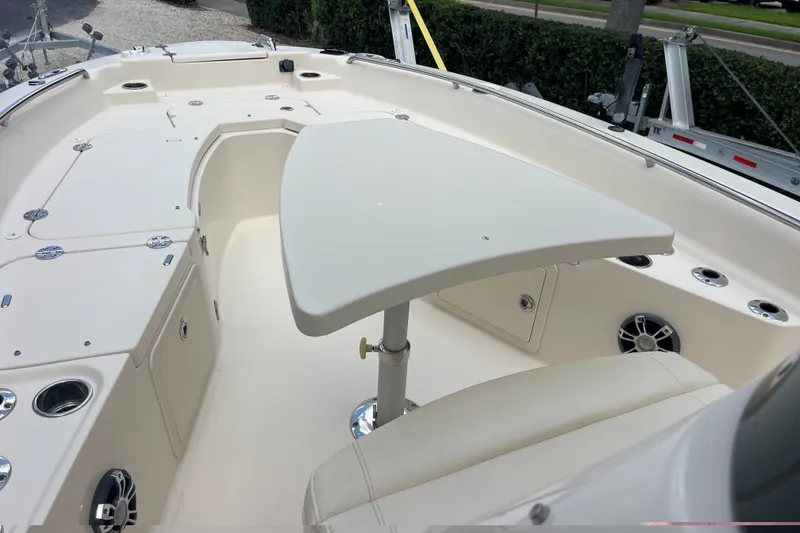Slide: The Image of 2022 Grady-White 251 Coastal Explorer boat interior with seating and table setup. - 18