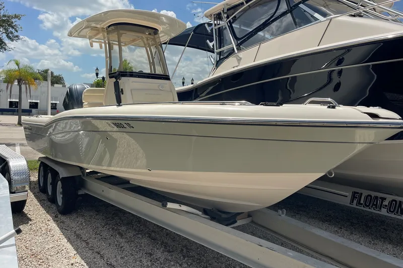 The Image of 2022 Grady-White 251 Coastal Explorer boat on trailer, parked outdoors. - 0