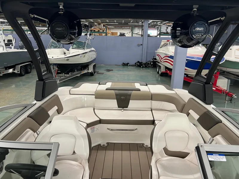 Slide: The Image of The image shows the interior of a 2021 Chaparral 23 SSi boat with sleek seating and speakers. - 19