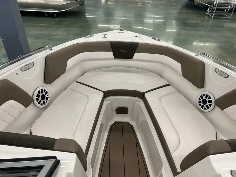 Slide: The Image of The image shows the bow area of a Chaparral 23 SSi boat with cushioned seating and speakers. - 16