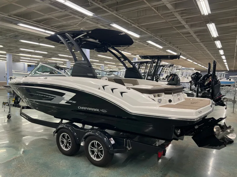Slide: The Image of A 2021 Chaparral 23 SSi boat on a trailer in a showroom. - 7