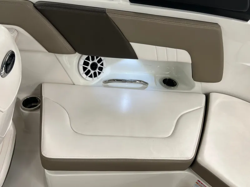 Slide: The Image of Interior view of a Chaparral 23 SSi boat with white and brown seating and speaker. - 21