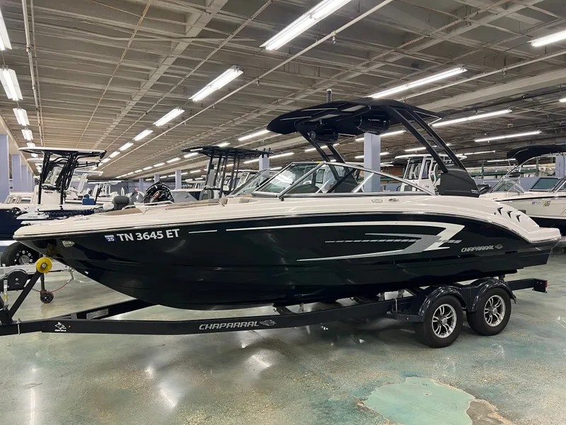 Slide: The Image of A 2021 Chaparral 23 SSi boat on a trailer in a showroom. - 6