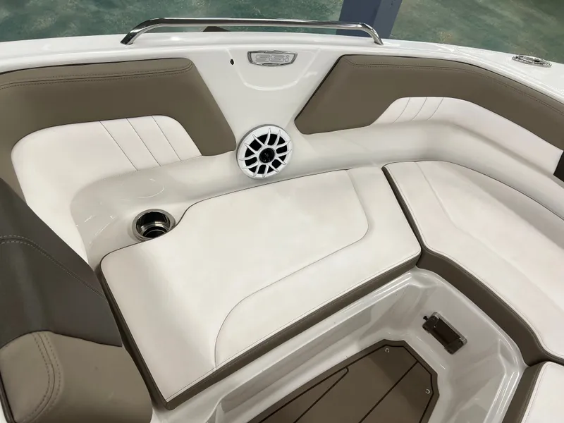 Slide: The Image of The image shows the bow area of a Chaparral 23 SSi boat with beige and white upholstery. - 17