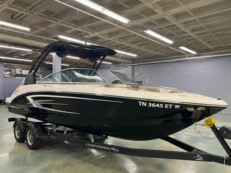 Slide: The Image of A 2021 Chaparral 23 SSi boat on a trailer in an indoor setting. - 11