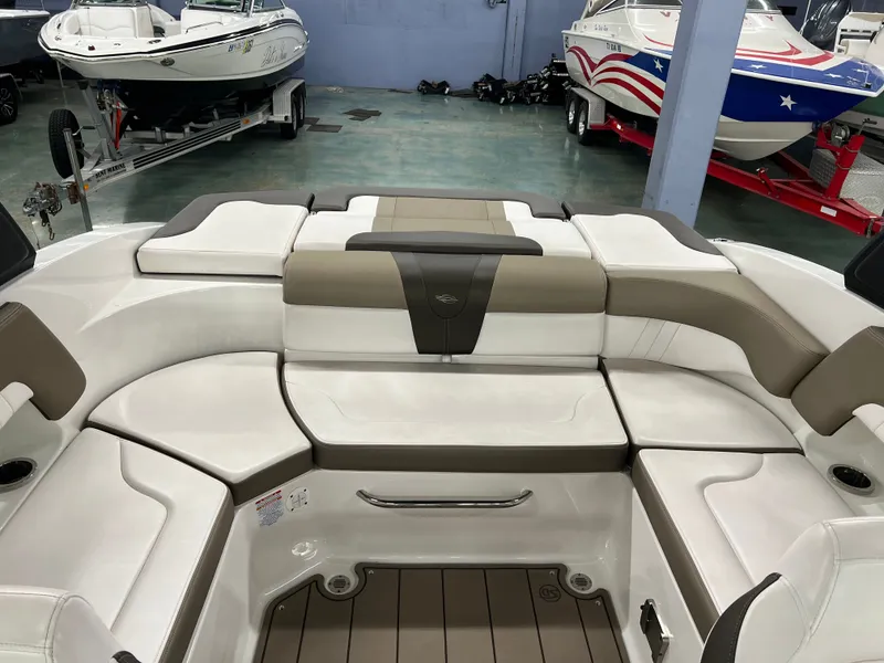 Slide: The Image of The image shows the cockpit of a Chaparral 23 SSi boat with beige and white upholstery. - 12