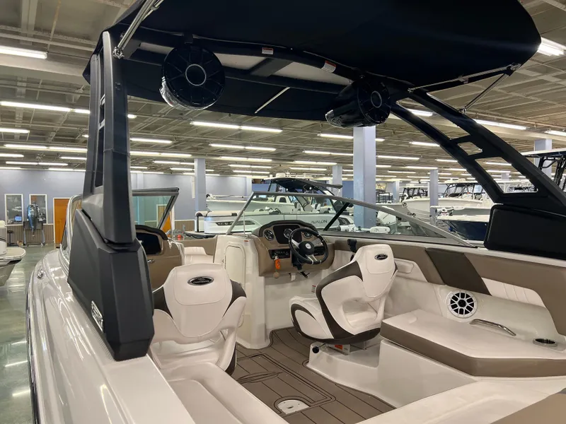 Slide: The Image of The image shows the interior of a 2021 Chaparral 23 SSi boat in a showroom. - 8