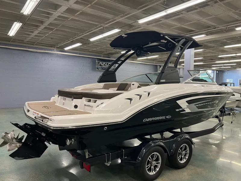 Slide: The Image of A 2021 Chaparral 23 SSi boat on a trailer in a showroom. - 10