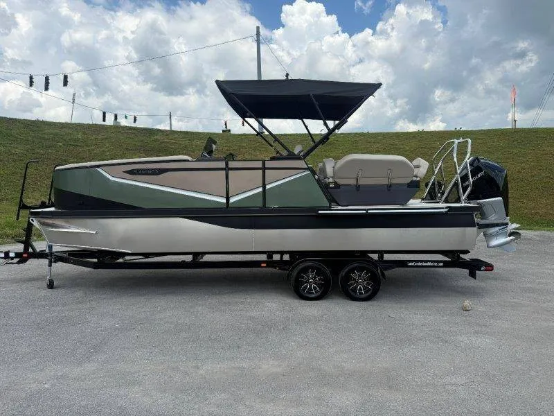Slide: The Image of The image shows a modern pontoon boat with a black canopy and sleek design. - 18