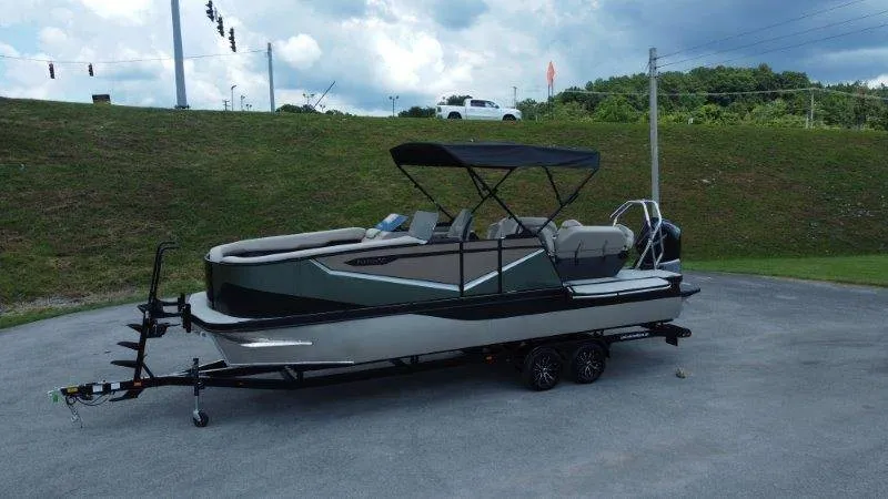 Slide: The Image of The image shows a 2027 Flamingo ROVE 245 boat on a trailer, featuring a black canopy. - 2