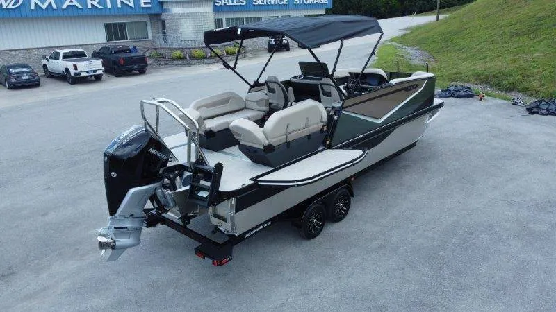 Slide: The Image of The image shows a modern pontoon boat on a trailer. It features a black canopy and beige seating. - 7