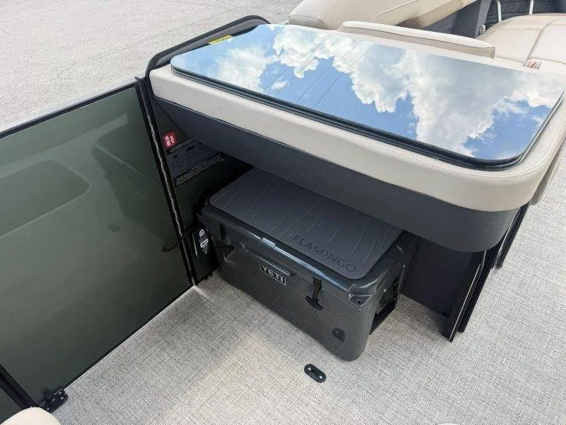 Slide: The Image of A sleek glass-top table reflects the sky. Below, there's a Flamingo cooler. - 32