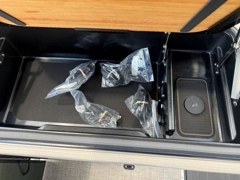 Slide: The Image of An open storage compartment with several plastic-wrapped items inside. - 44