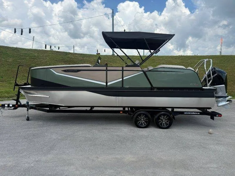 Slide: The Image of A modern Flamingo ROVE 245 pontoon boat from 2027 on a trailer, featuring a black canopy. - 15