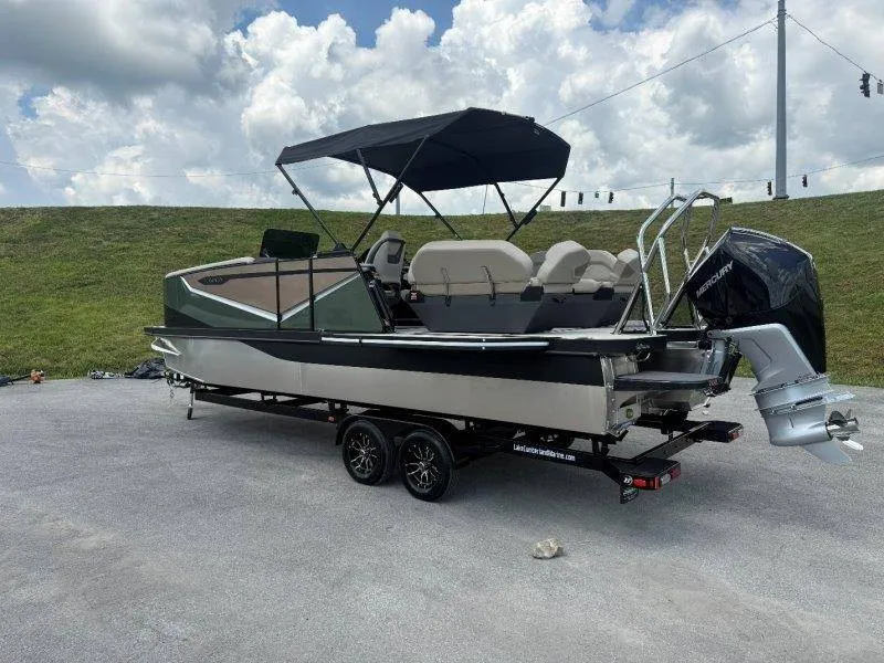 Slide: The Image of A modern pontoon boat with a black canopy and outboard motor sits on a trailer. - 24