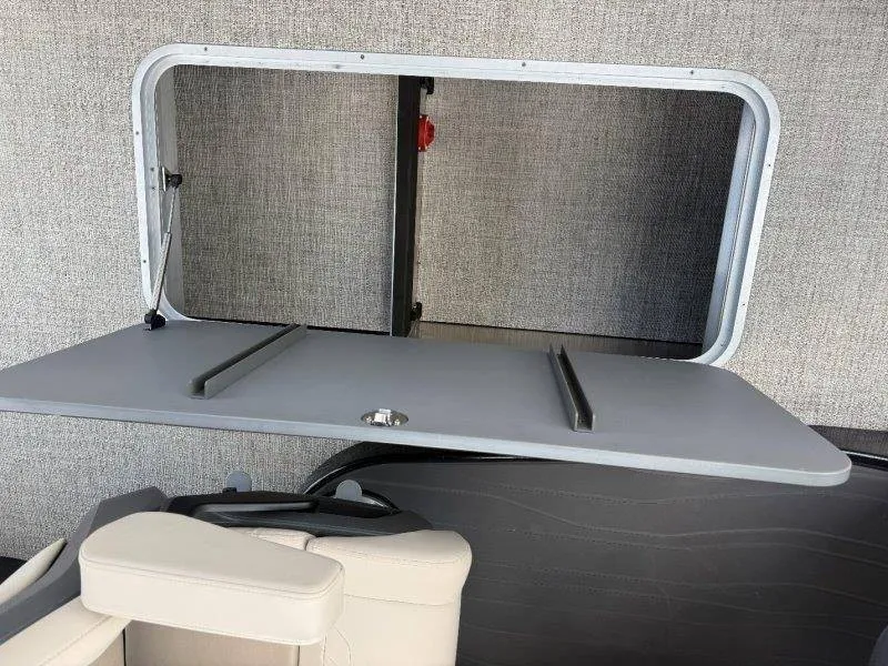Slide: The Image of A gray folding table in a boat with beige seating and gray wall paneling. - 39