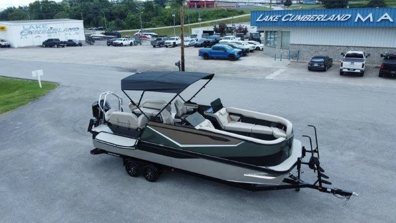 Slide: The Image of A 2027 Flamingo ROVE 245 pontoon boat on a trailer in front of a building. - 11
