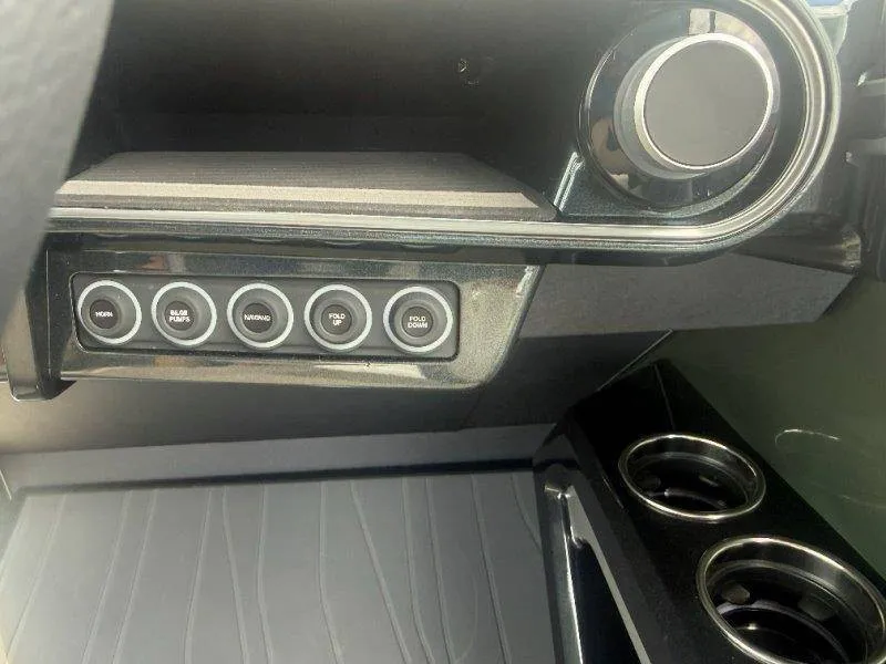 Slide: The Image of The image shows the dashboard of a Flamingo ROVE 245 boat with controls and cup holders. - 47