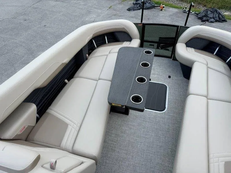 Slide: The Image of The image shows the interior of a 2027 Flamingo ROVE 245 boat with beige seating and a table. - 34