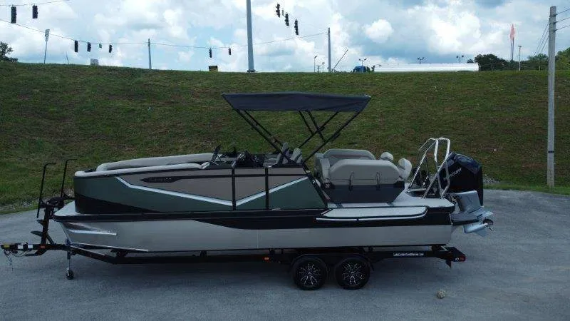 Slide: The Image of A 2027 Flamingo ROVE 245 pontoon boat on a trailer. It features a black canopy. - 6