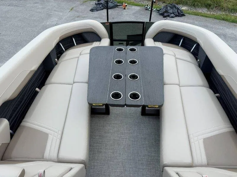 Slide: The Image of The image shows the interior of a 2027 Flamingo ROVE 245 boat with beige seating and a table. - 33