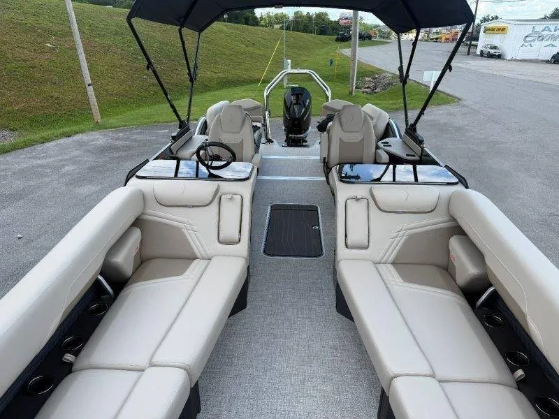 Slide: The Image of The image shows the interior of a Flamingo ROVE 245 boat with beige seating and a black canopy. - 37