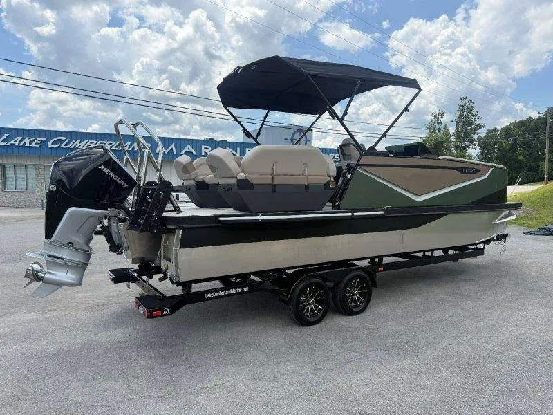 Slide: The Image of A modern 2027 Flamingo ROVE 245 on a trailer, featuring a black sunshade and outboard motor. - 21