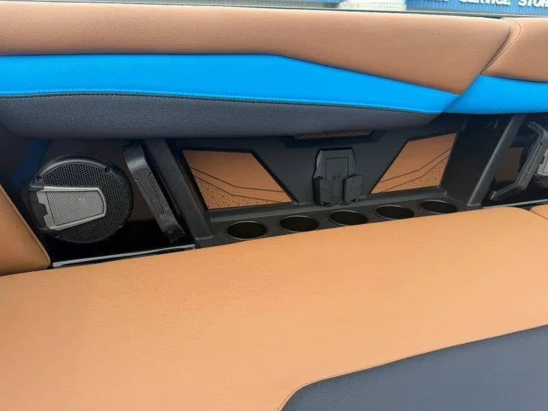 Slide: The Image of The interior of a 2027 Axis A245 boat with brown and blue upholstery and speakers. - 40