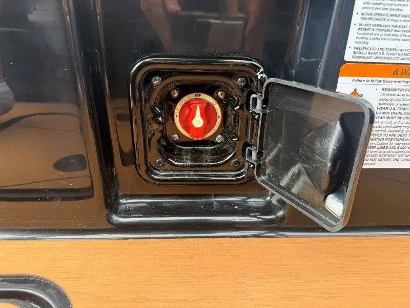 Slide: The Image of A black control panel with a red switch and an open cover. - 42