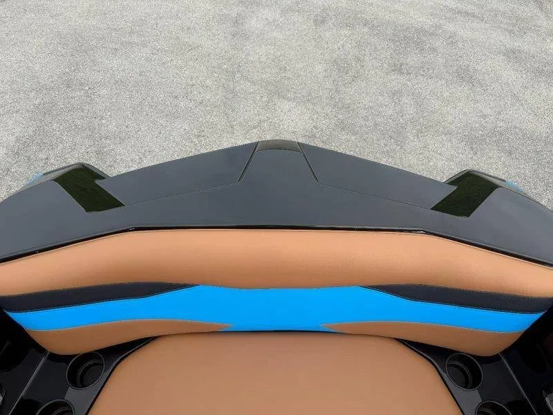 Slide: The Image of Close-up of a boat seat with brown and blue upholstery, surrounded by black material. - 43