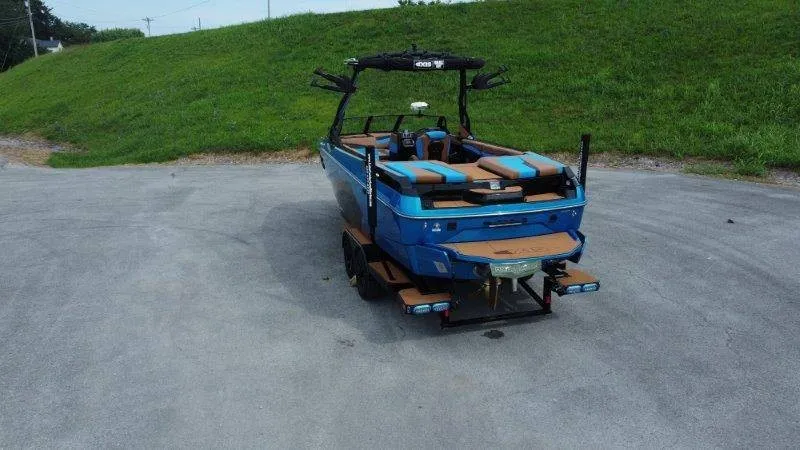 Slide: The Image of A blue 2027 Axis A245 on a trailer in a parking area. - 4