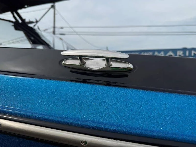 Slide: The Image of Close-up of a shiny blue boat with a silver cleat fitting. - 19